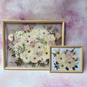 Pressed white and cream flowers in a natural wood floating frame, with a matching smaller keepsake frame.