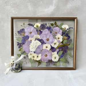Pressed lavender, purple and white flowers in a dark wood floating frame, shown with a matching flower ornament.